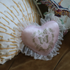 Vintage-style love pillow with soft fabric and elegant lace trim